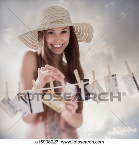 Stock Photo - Woman hanging credit cards on clothesline. Fotosearch