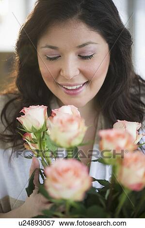 Stock Photo - Woman holding a bouquet of roses. Fotosearch