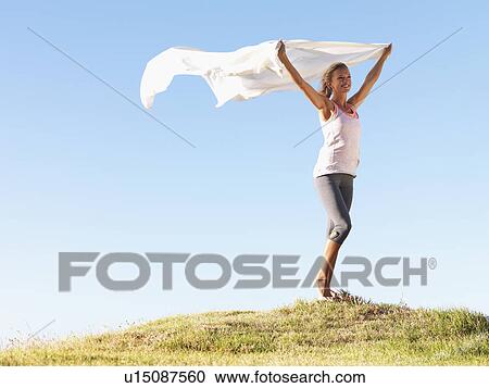 Woman holding a white scarf over her head View Large Photo Image Stock Image - Woman holding a white scarf over her head. Fotosearch