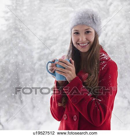 Woman in the snow holding a warm drink View Large Photo Image Stock Image - Woman in the snow holding a warm drink. Fotosearch