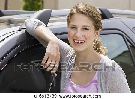 Woman leaning against her new car View Large Photo Image Stock Photo - Woman leaning against her new car. Fotosearch