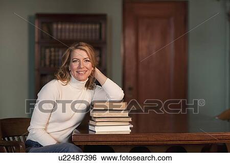 Woman leaning on stack of books View Large Photo Image Stock Photograph - Woman leaning on stack of books. Fotosearch