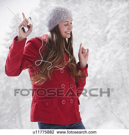 Stock Image - Woman listening to music on her I pod. Fotosearch