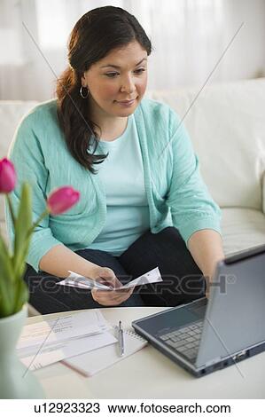Woman paying bills online View Large Photo Image Stock Image - Woman paying bills online. Fotosearch