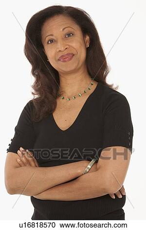Woman standing with her arms crossed View Large Photo Image Stock Image - Woman standing with her arms crossed. Fotosearch
