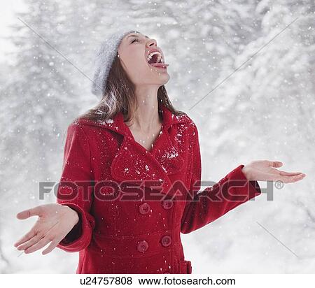 Woman trying to catch snow on her tongue View Large Photo Image Stock Photo - Woman trying to catch snow on her tongue. Fotosearch