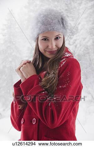 Woman wearing a red winter coat View Large Photo Image Picture - Woman wearing a red winter coat. Fotosearch