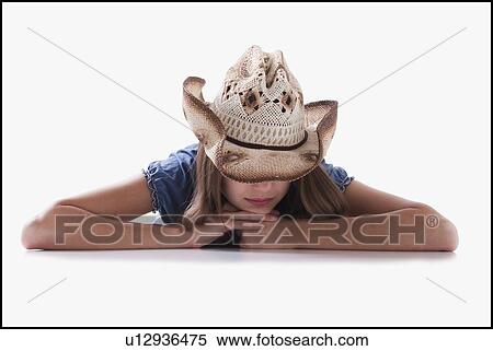 Woman wearing cowboy hat that covers her eyes View Large Photo Image Stock Photography - Woman wearing cowboy hat that covers her eyes. Fotosearch