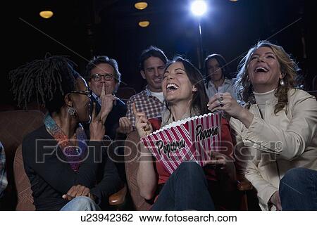 Women laughing loudly in movie theatre View Large Photo Image Stock Image - Women laughing loudly in movie theatre. Fotosearch