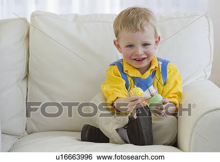 Young child holding Easter eggs View Large Photo Image Stock Photograph - Young child holding Easter eggs. Fotosearch