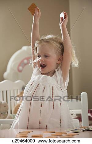 Stock Photo - Young girl playing memory game. Fotosearch