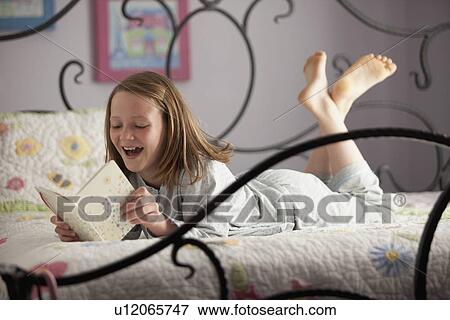 Stock Photo - Young girl reading her diary. Fotosearch