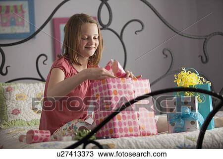 Young girl wrapping presents View Large Photo Image Stock Image - Young girl wrapping presents. Fotosearch