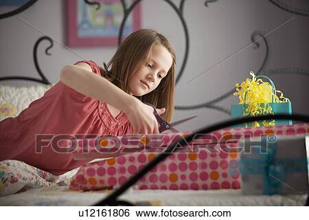 Young girl wrapping presents View Large Photo Image Stock Photograph - Young girl wrapping presents. Fotosearch