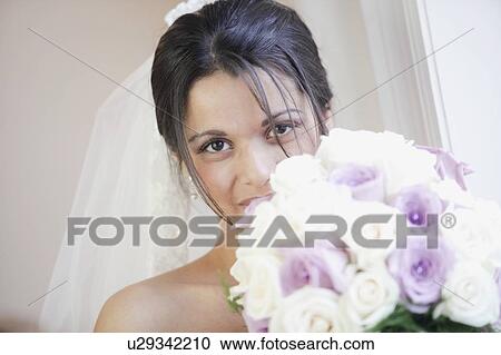 Stock Image - A Bride Holding Her Bouquet. Fotosearch