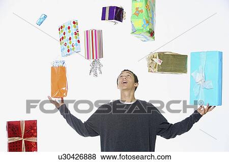 a man juggling holiday gifts View Large Photo Image Stock Photo - a man juggling holiday gifts. Fotosearch