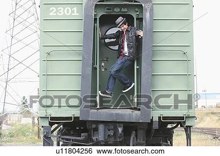 a teenage boy having fun on a train; portland, oregon, united states of america View Large Photo Image Stock Photograph - a teenage boy having fun on a train; portland, oregon, united states of america. Fotosearch