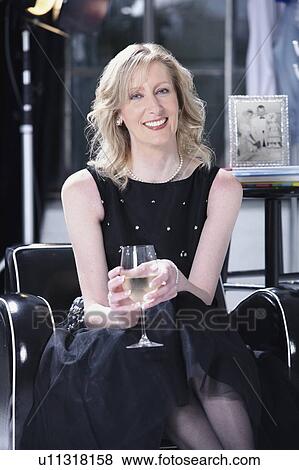 Stock Photo - a woman relaxing in her studio. Fotosearch