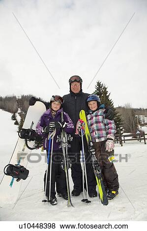 red deer, alberta, canada; a father and two daughters at a ski area holding a snowboard and skiis View Large Photo Image Stock Photo - red deer, alberta, canada; a father and two daughters at a ski area holding a snowboard and skiis. Fotosearch