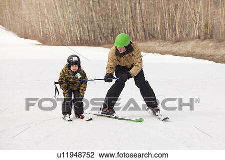 red deer, alberta, canada; a father teaching his young son how to ski View Large Photo Image Stock Image - red deer, alberta, canada; a father teaching his young son how to ski. Fotosearch