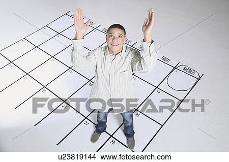 teenage boy standing on a calendar View Large Photo Image Picture - teenage boy standing on a calendar. Fotosearch