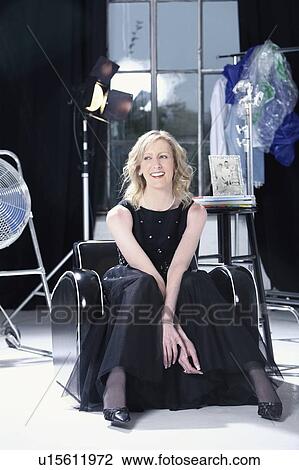 Stock Image - woman relaxing in her studio. Fotosearch