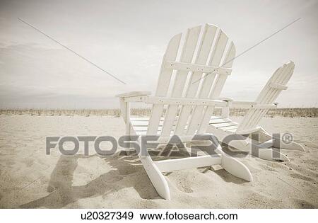 Stock Photo - Adirondack chairs on the beach. Fotosearch