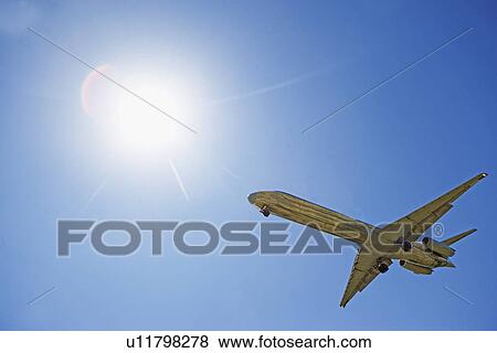 Stock Photo - Airplane flying in the sky. Fotosearch