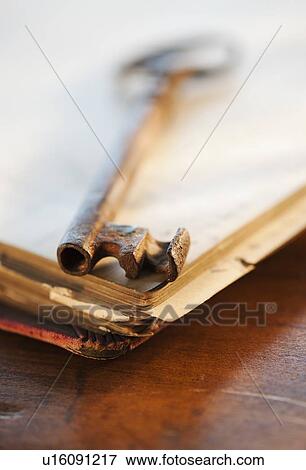 Stock Photo - Antique key on top of book. Fotosearch