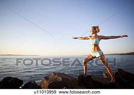 Stock Photo - Athletic woman stretching outdoors. Fotosearch