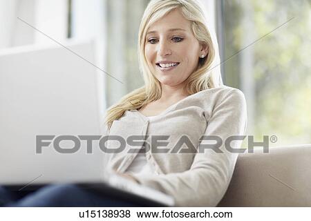 Attractive blond woman browsing the internet View Large Photo Image Stock Photo - Attractive blond woman browsing the internet. Fotosearch