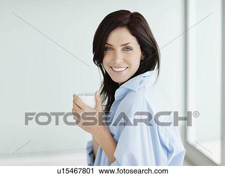 Attractive brunette drinking coffee View Large Photo Image Stock Image - Attractive brunette drinking coffee. Fotosearch