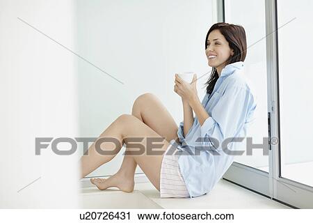 Attractive brunette drinking coffee View Large Photo Image Stock Image - Attractive brunette drinking coffee. Fotosearch