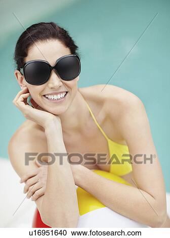 Attractive brunette wearing sunglasses and bikini View Large Photo Image Stock Image - Attractive brunette wearing sunglasses and bikini. Fotosearch