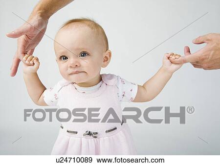 Stock Photo - Baby holding father`s fingers. Fotosearch
