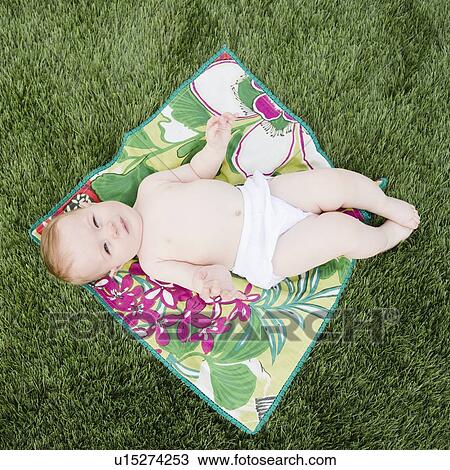Baby on blanket on the grass View Large Photo Image Stock Image - Baby on blanket on the grass. Fotosearch