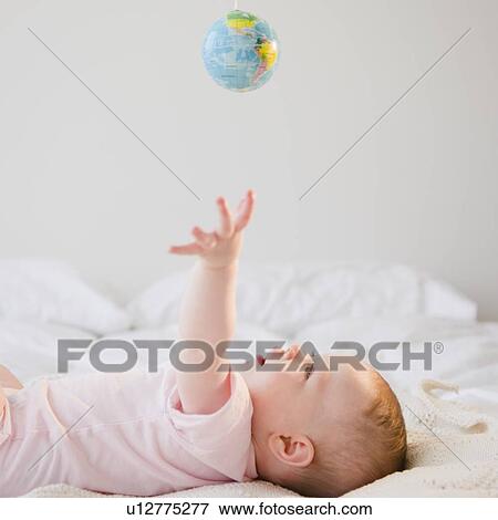 Baby reaching for globe View Large Photo Image Stock Photo - Baby reaching for globe. Fotosearch