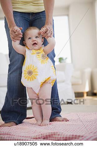Baby's first steps View Large Photo Image Stock Photography - Baby's first steps. Fotosearch