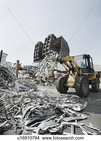 Picture - Backhoe lifting recycled metal. Fotosearch