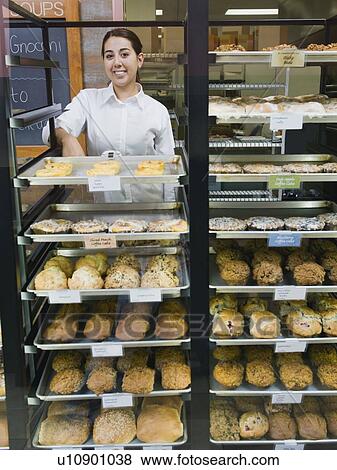 Baker standing behind trays of baked goods View Large Photo Image Stock Photo - Baker standing behind trays of baked goods. Fotosearch