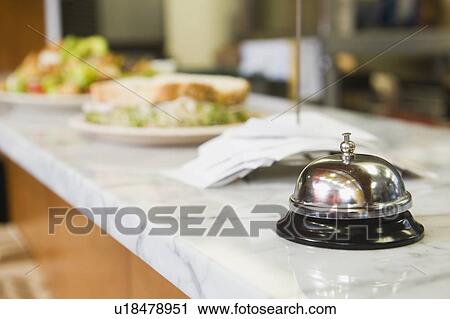Bell on counter in restaurant View Large Photo Image Stock Image - Bell on counter in restaurant. Fotosearch