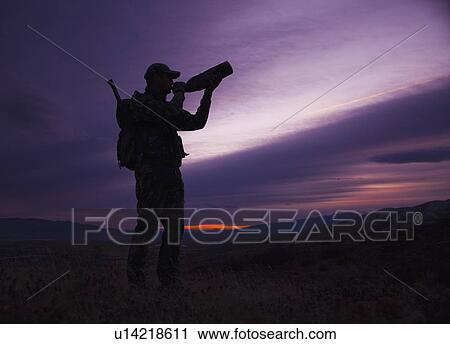 Stock Image - Big game hunter at dusk. Fotosearch
