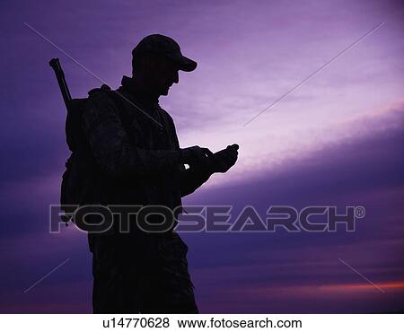 Stock Photo - Big game hunter at dusk. Fotosearch