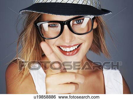 Stock Photograph - Blond woman wearing sunglasses and sunhat. Fotosearch