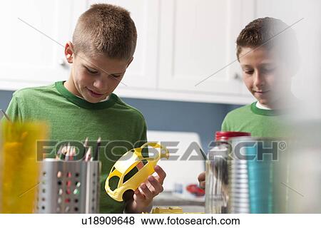 Stock Photo - Boys building model cars. Fotosearch