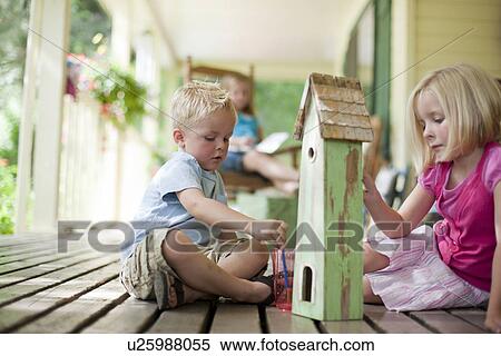Brother and sister painting birdhouse together View Large Photo Image Stock Photography - Brother and sister painting birdhouse together. Fotosearch