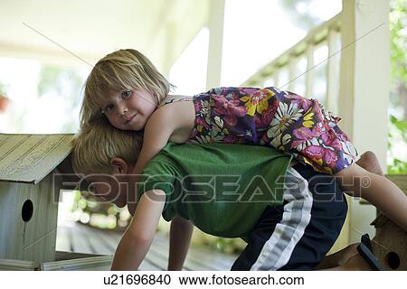 Stock Image - Brother and sister playing together. Fotosearch