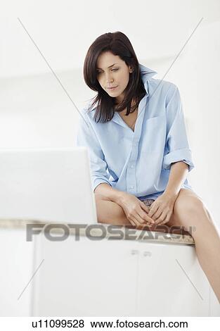 Brunette woman browsing the internet View Large Photo Image Stock Photo - Brunette woman browsing the internet. Fotosearch