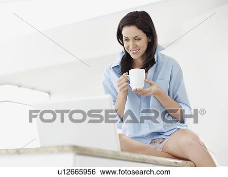 Brunette woman browsing the internet View Large Photo Image Stock Photograph - Brunette woman browsing the internet. Fotosearch