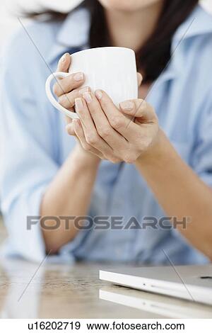 Stock Photo - Brunette woman drinking coffee. Fotosearch